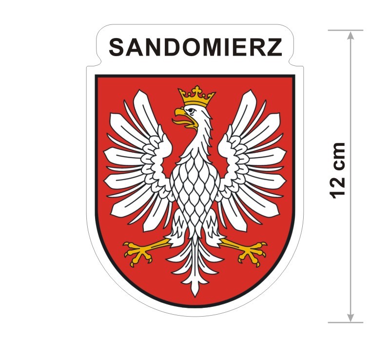 Naklejka z herbem Sandomierza, nad herbem jest umieszczony napis Sandomierz. Herb wraz z nazwą otoczone są białą obwódką stanowiącą białe tło naklejki. Obok podano wymiar wysokości naklejki - 12 cm.