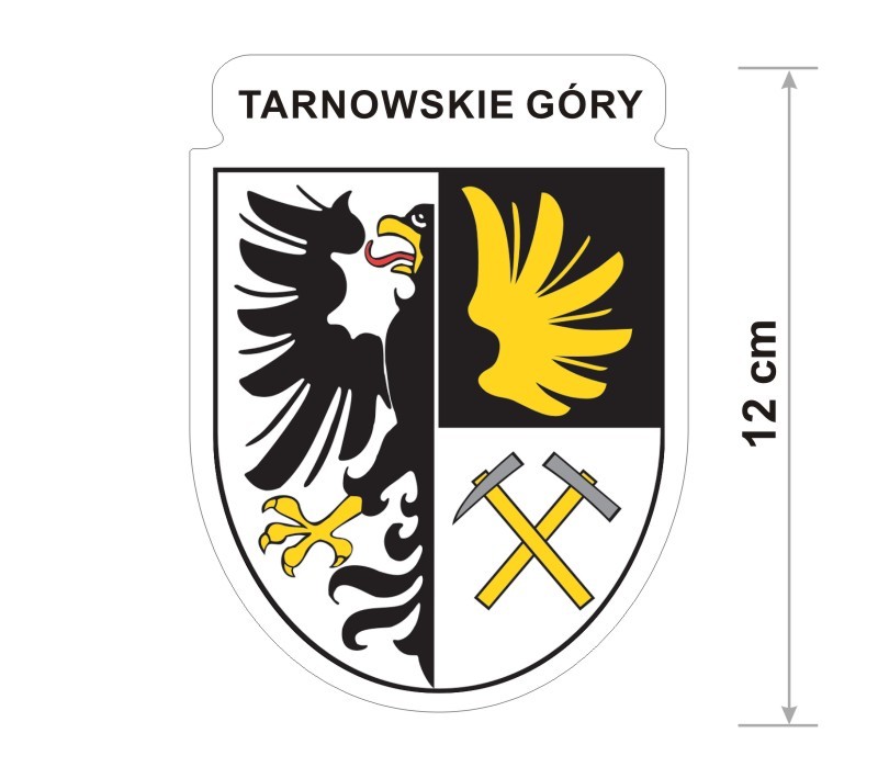 Naklejka z herbem Tarnowskich Gór, nad herbem jest umieszczony napis Tarnowskie Góry. Herb wraz z nazwą otoczone są białą obwódką stanowiącą białe tło naklejki. Obok podano wymiar wysokości naklejki - 12 cm.